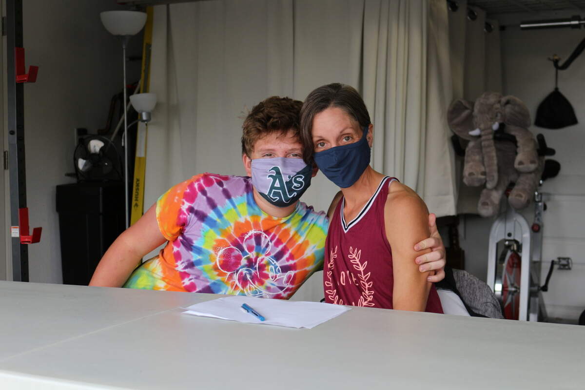 Hunter Wooldridge hugs his mom, Serema, in their home in Arroyo Grande on Oct. 25, 2020. Hunter struggled to keep his grades up last year, despite being a straight-A student in previous years.