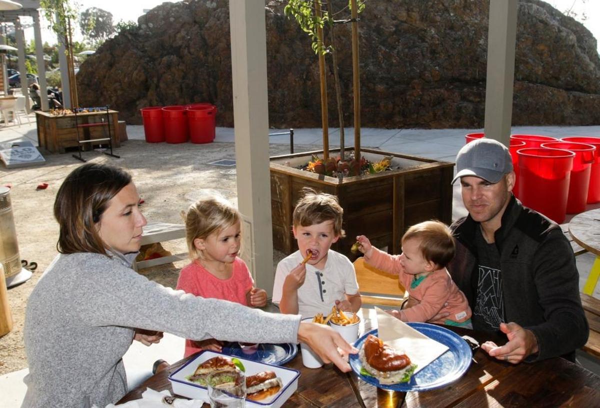 Katie, 2-year-old Julia, 4-year-old Lucas, 10-month-old Audrey, and Matt Walsh enjoy a meal and beverages at SLO Brew’s The Rock location near the San Luis Obispo County airport.