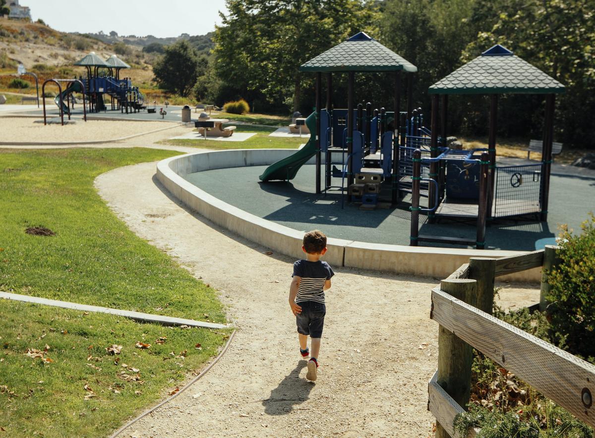 Chumash Park in Pismo Beach features play areas next to a wooded area.