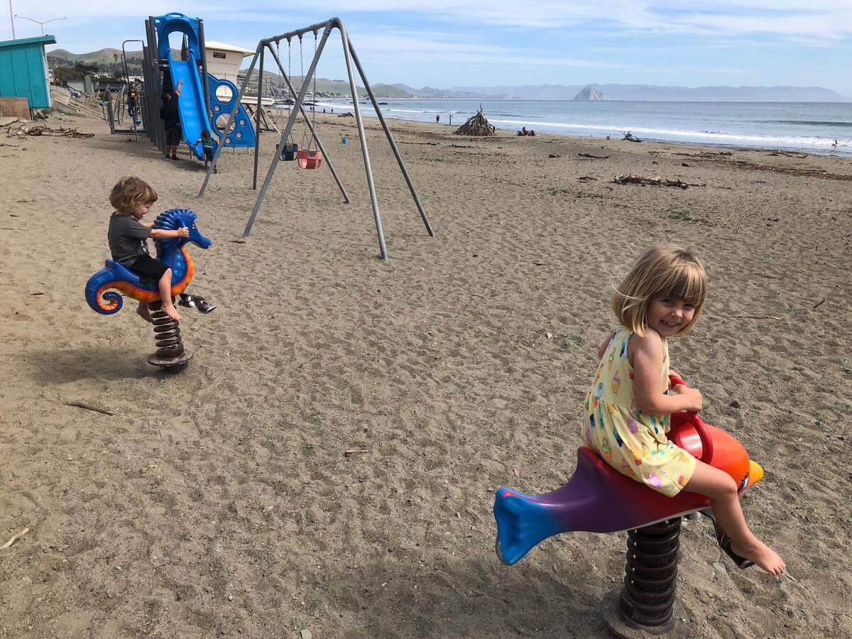Wyatt and Clara enjoy the playground at Cayucos State Beach.