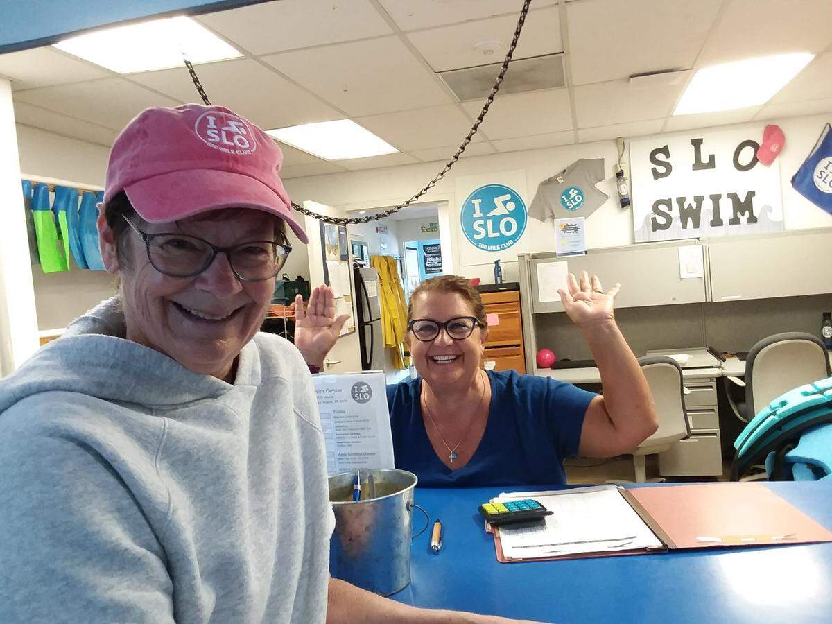Retired therapist Linda Lewis Griffith, left, celebrates with Missy Teel at SLO Swim Center in San Luis Obispo after swimming 100 miles in a year.