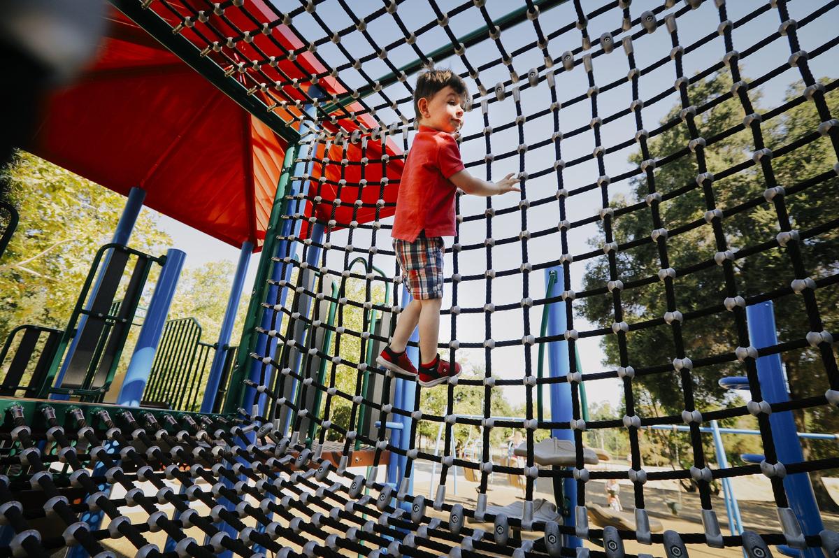 The playground at Atascadero Lake Park boasts a net bridge that offers lots of climbing fun.