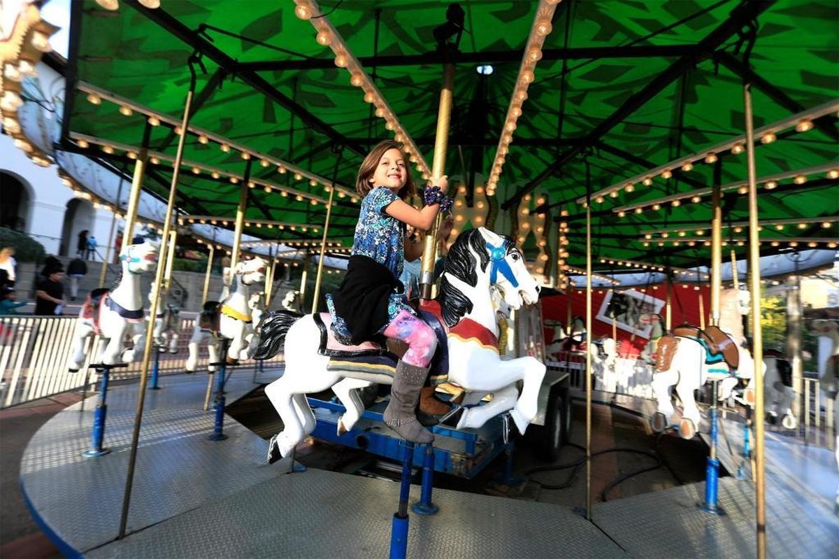 Kids take a ride on the classic carousel in Mission Plaza in downtown San Luis Obispo in 2016.