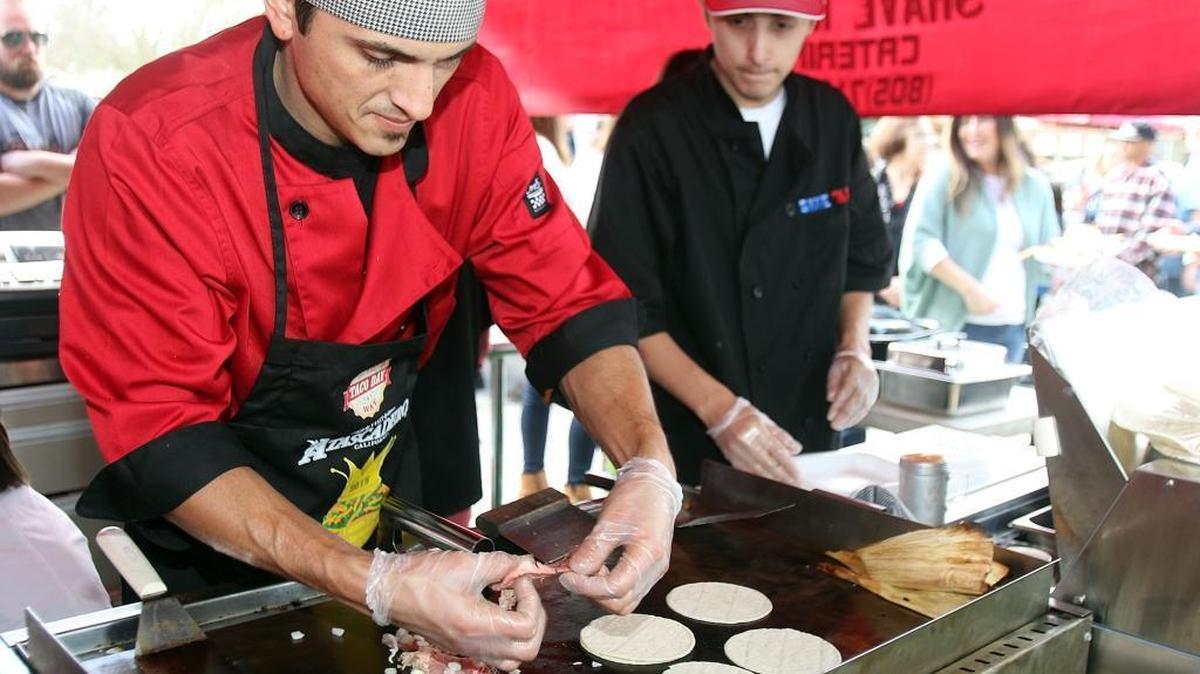 Steven and Eric Sullivan cook tamales, tacos and more for the hungry crowd at the Tamale Festival in Atascadero in 2016. The Atascadero Tamale Festival was canceled in 2023 due to severe winter weather.
