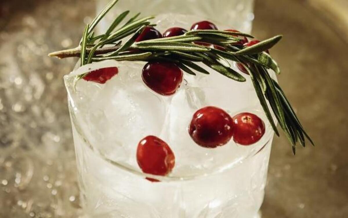 The Winter Mule cocktail, created by Root Elixirs founder Dominique Gonzales, features spirits and ginger beer soda garnished with fresh cranberries and a rosemary spring.