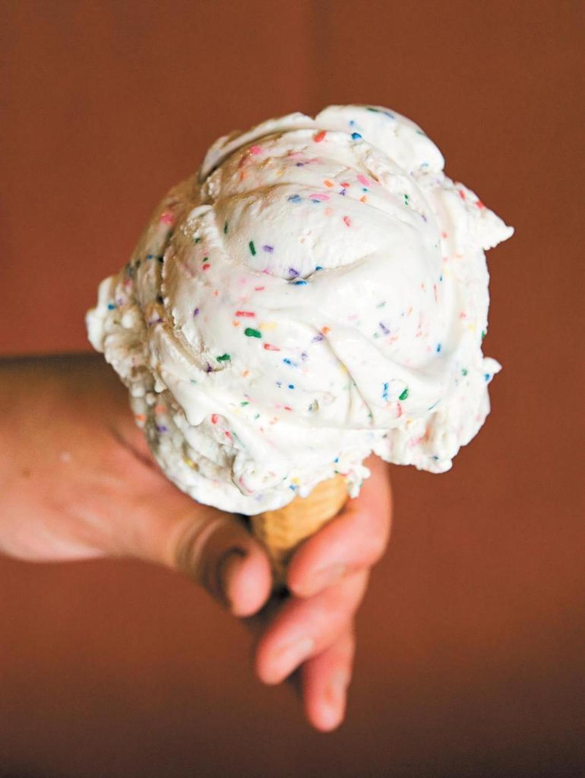 A scoop of Doc Burnstein’s Birthday Cake ice cream on a sugar cone.