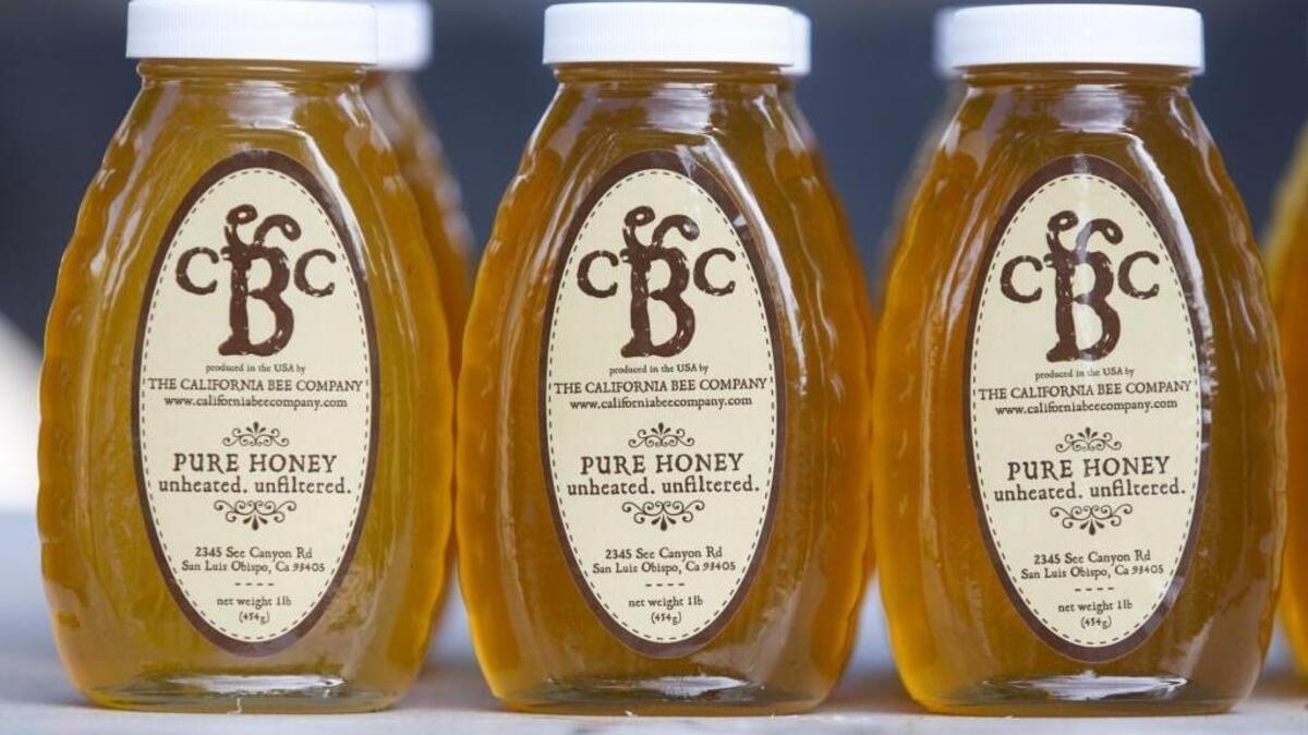 Jars of California Bee Company honey are sold at the Atascadero farmers market.