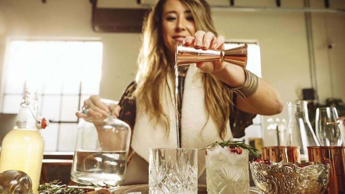 Root Elixirs founder Dominique Gonzales prepares a Winter Mule cocktail featuring her San Luis Obispo company’s Ginger Beer soda.