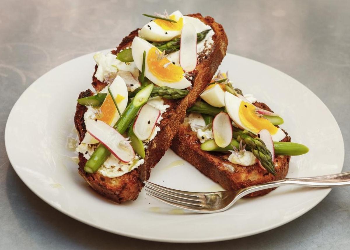 Thomas Hill Organics chef Tim Veatchâ’s asparagus tartine with chevre, radish, soft boiled egg and chive blossoms.