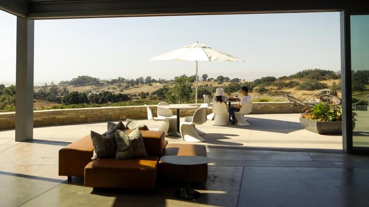 A couple enjoys wine and the views at Presqu’ile Winery in Santa Maria.