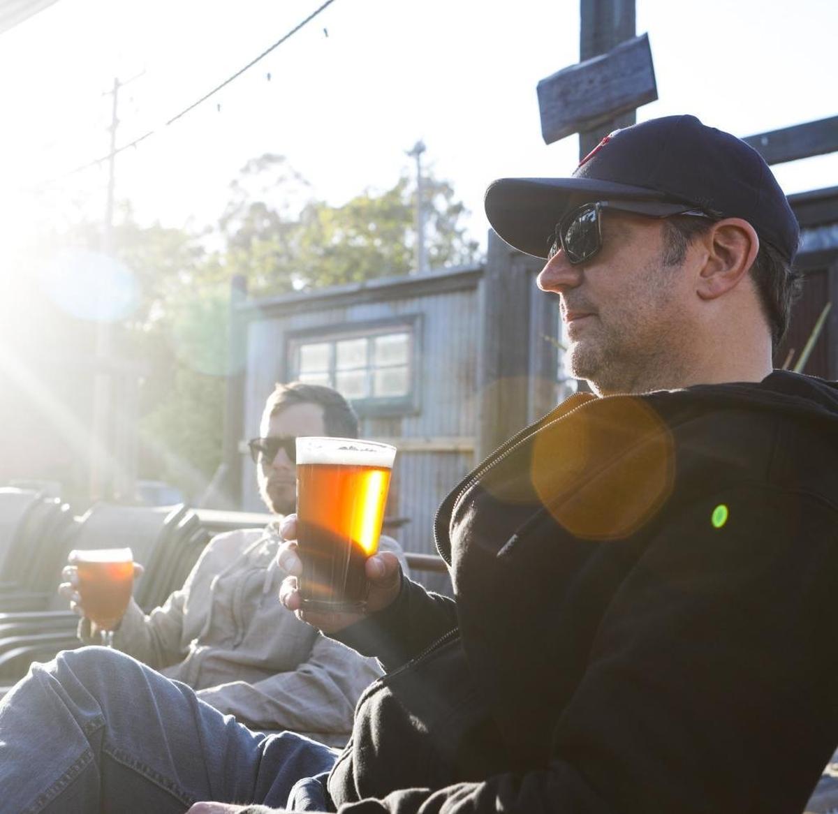Jon King, left, and Ben Erchul enjoy beers at Bang the Drum Brewery in San Luis Obispo.