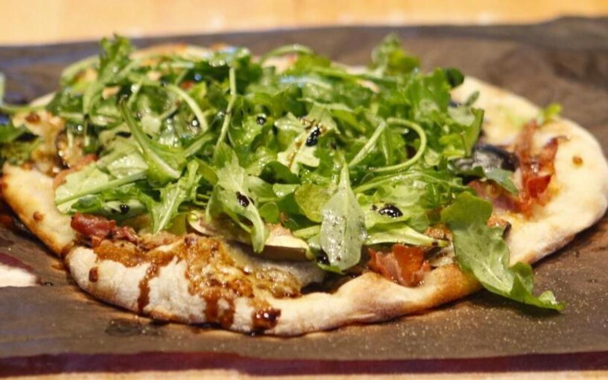 Figs, prosciutto, smoked mozarella and arugula are featured in The Pig and the Fig pizza, crafted as part of an “Art of Artisan Pizza” cooking class at Refugio Kitchen in Paso Robles.