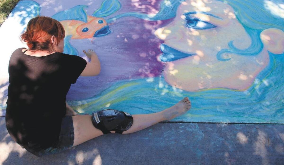 Brittani Taylor of Paso Robles works on a chalk street painting as part of Arte de Tiza in Paso Robles. The event coincides with Taste of Downtown in Paso Robles.