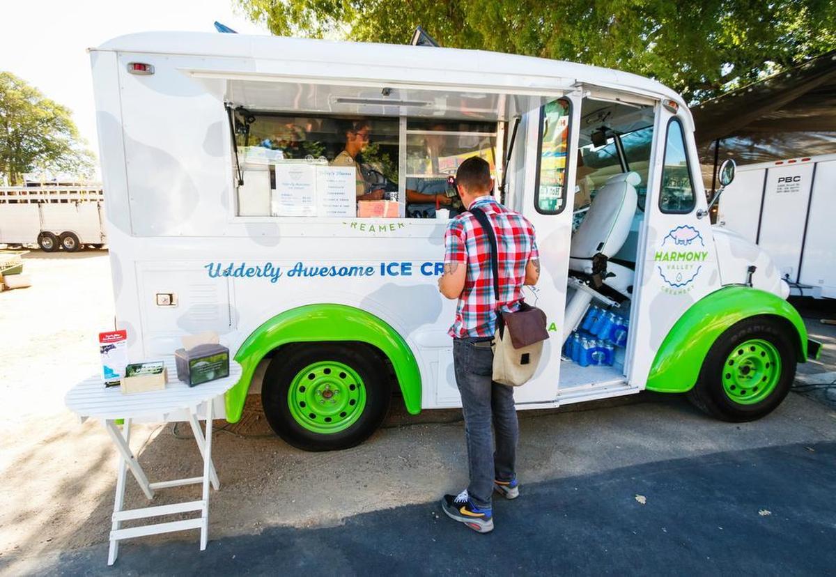 Tribune reporter Travis Gibson puts in an order at the Harmony Valley Creamery ice cream truck at the California Mid-State Fair in Paso Robles.