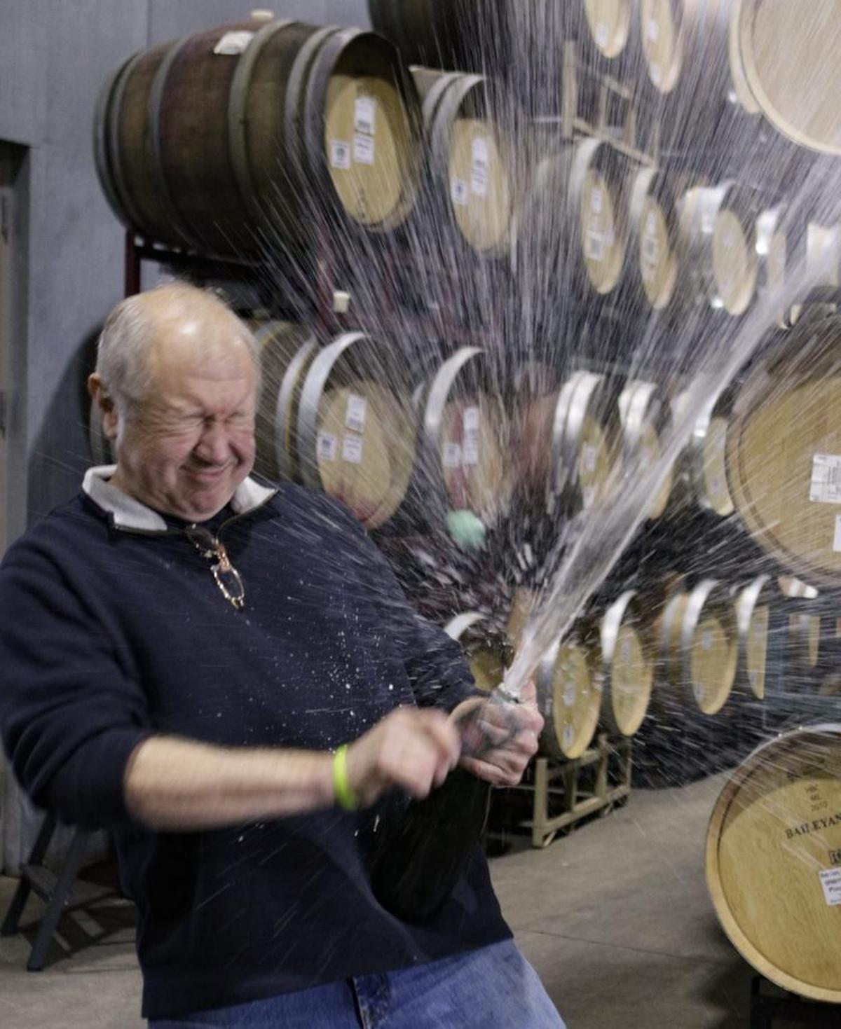 Christian Roguenant, winemaker for Niven Family Wine Estates in San Luis Obispo, disgorges sediment from a bottle of sparkling wine in 2016. The bottle must be quickly restoppered to prevent the loss of bubbly.