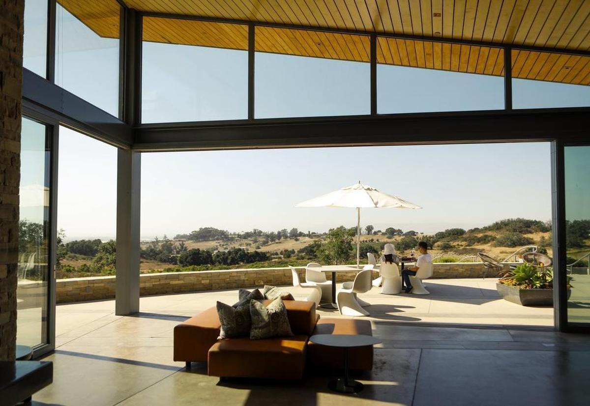A couple enjoys wine and the views at Presqu’ile Winery in Santa Maria.