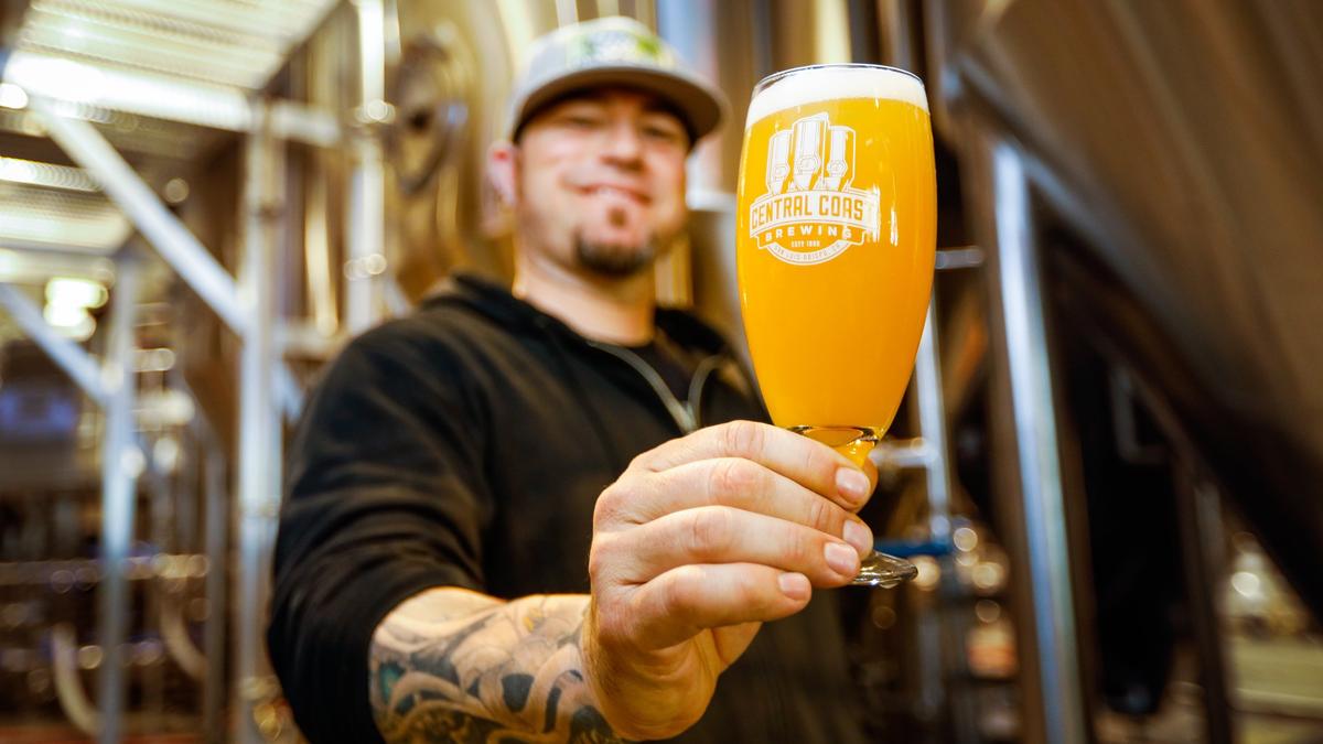 Brendan Gough, award-winning head brewer of Central Coast Brewing in San Luis Obispo, poses for a picture with one of the brewery’s hazy IPAs.