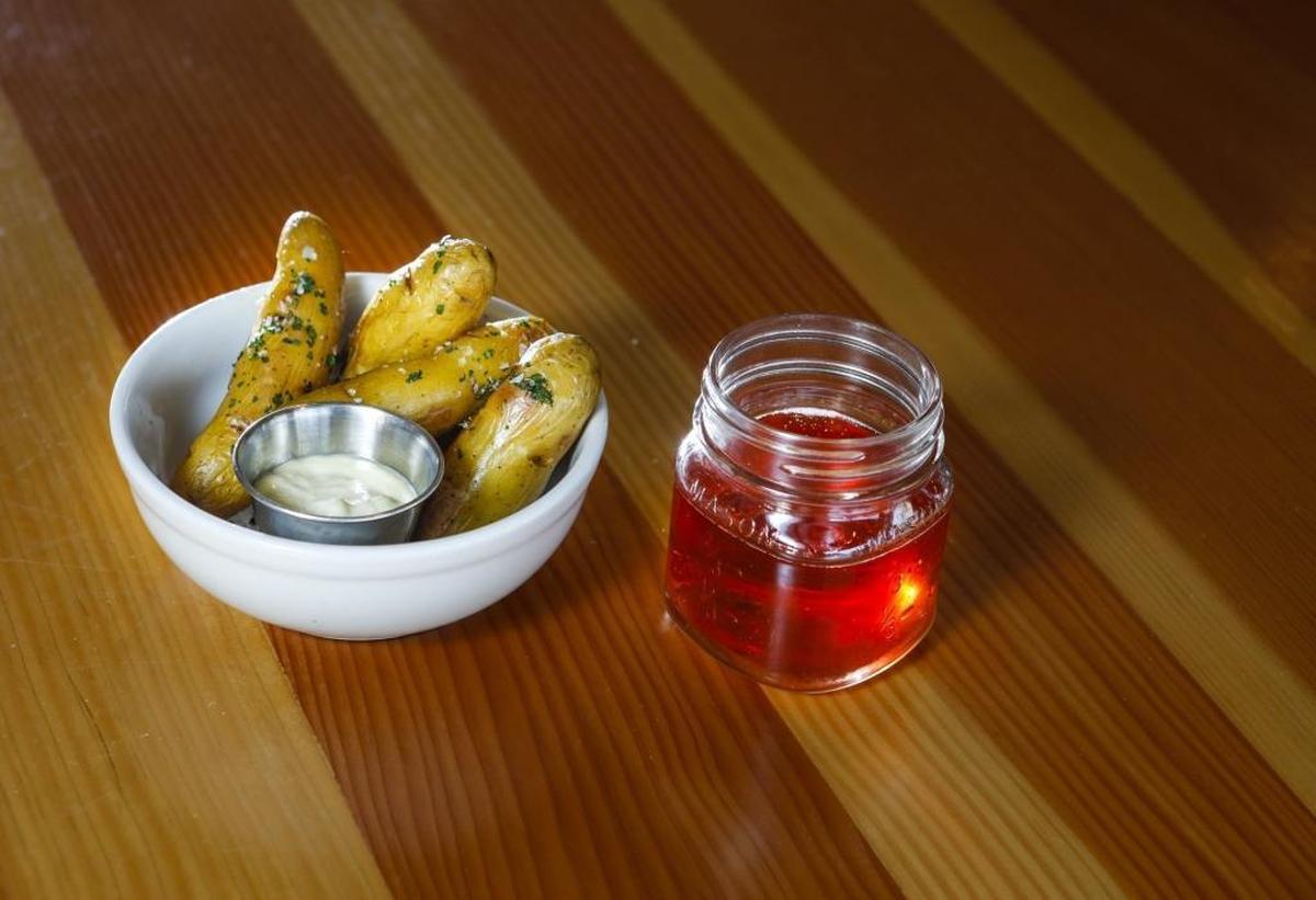 The Spoon Trade’s smoked potatoes with lime aioli are paired with Tin City Cider’s Cherry Saison — “a fun, tart way to cut through the richness of the potatoes,” says Brooke Town, co-owner of the Grover Beach restaurant.