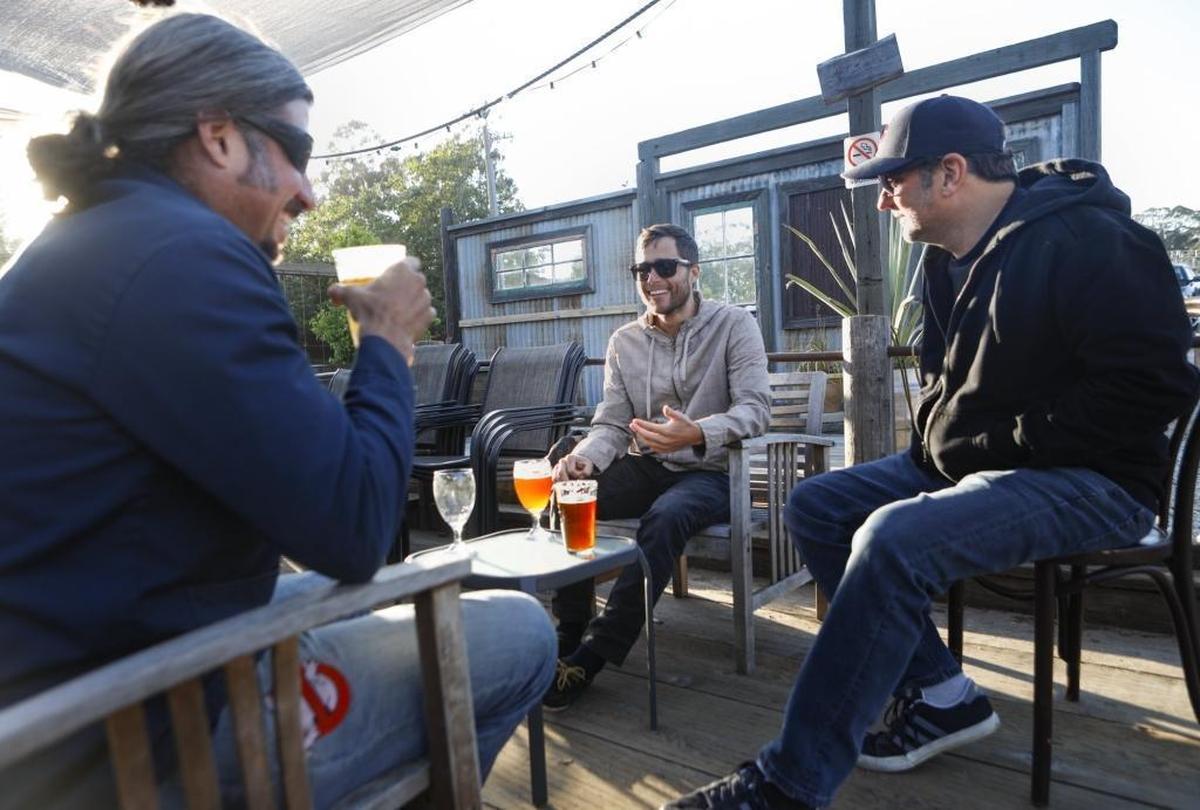 Jason Hilford, Jon King and Ben Erchul enjoy beers at Bang the Drum Brewery in San Luis Obispo.