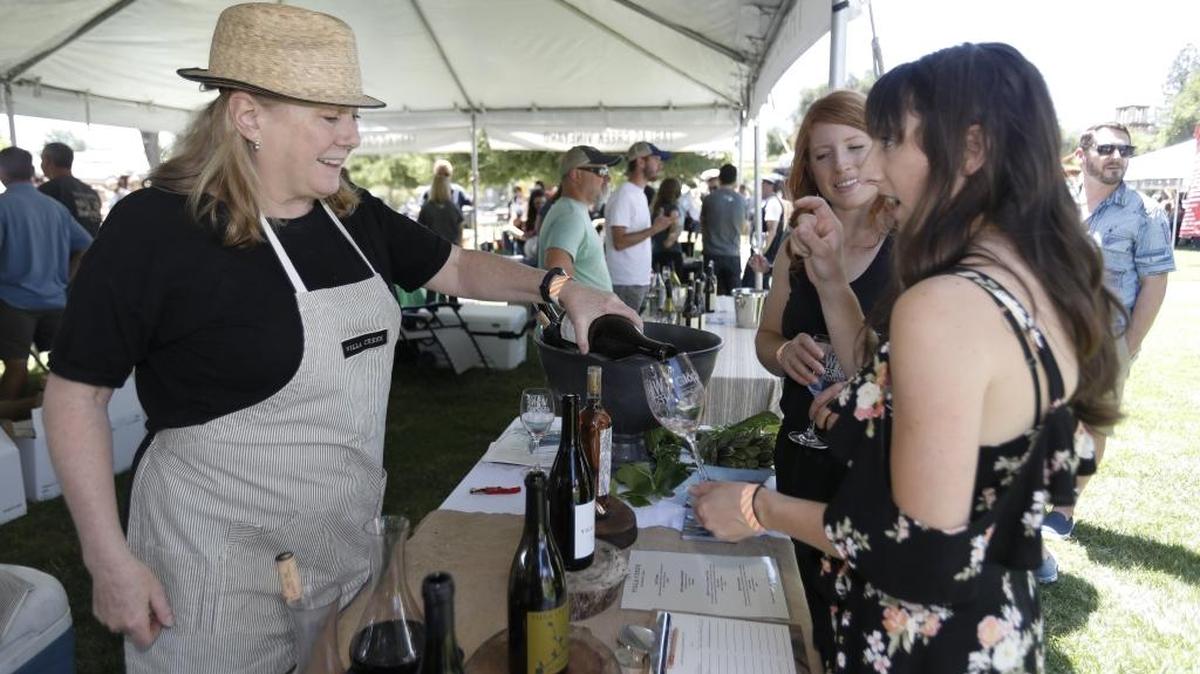 The 36th Annual Paso Robles Wine Festival began Friday, May 18, 2018 and culminated with the Grand Tasting on Saturday, in City Park. Katie Bruce of San Luis Obispo tries a Villa Creek Grenache Blanc pour with her friend Liz Schteiden, also of San Luis Obispo.