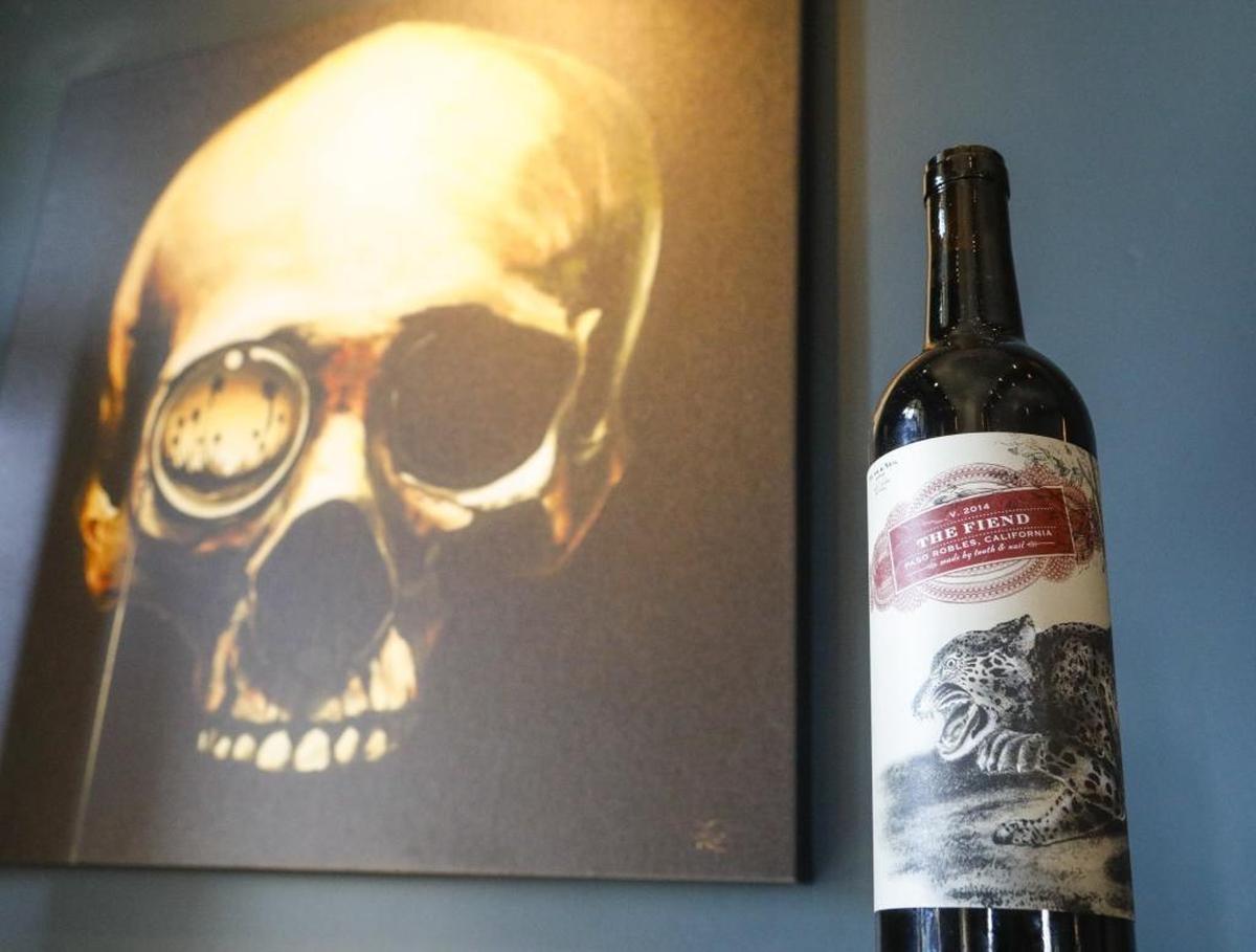 At Tooth & Nail Winery in Paso Robles, a bottle of The Fiend sits near macabre artwork.