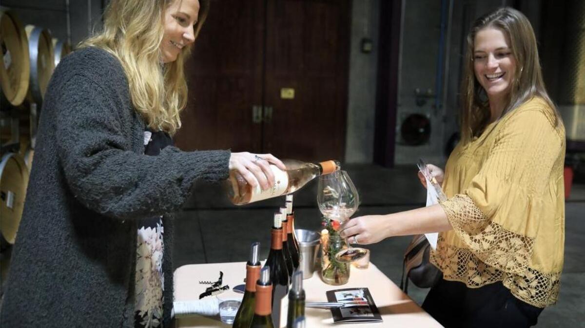 Chamisal Vineyards tasting room associate Aislinn Sexton-Moyer pours a glass of rosé for Kristin Newsom of San Luis Obispo at a Feb. 10 release party at the San Luis Obispo winery’s Orcutt Road production facility.