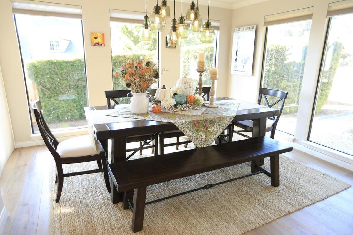 In the dining room of Doug and Shelly Schultz’s Cambria home, a cream and tan color palette is enlivened by yellow, orange and blue accent colors.