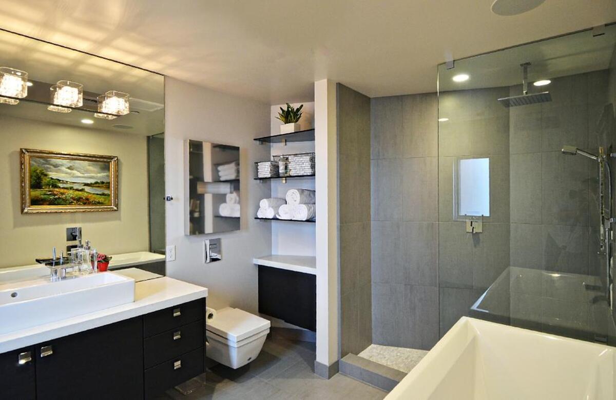 A traditional painting is on display in the sleek, modern bathroom.