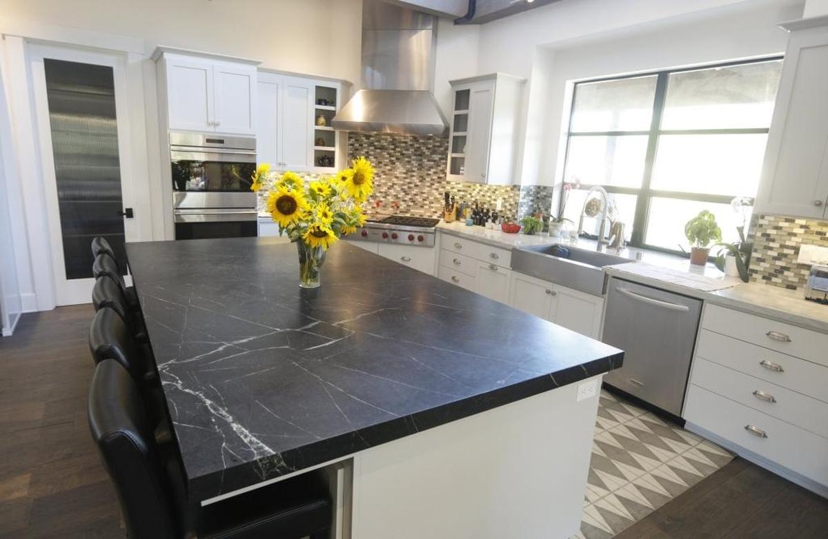 The kitchen features a 9-by-5-foot island that is one solid slab of soapstone, with no stove or sink to break up its sleek lines. Soapstone was ideal for this application because it “is impervious to acid and heat,” said Doug Kilgour.