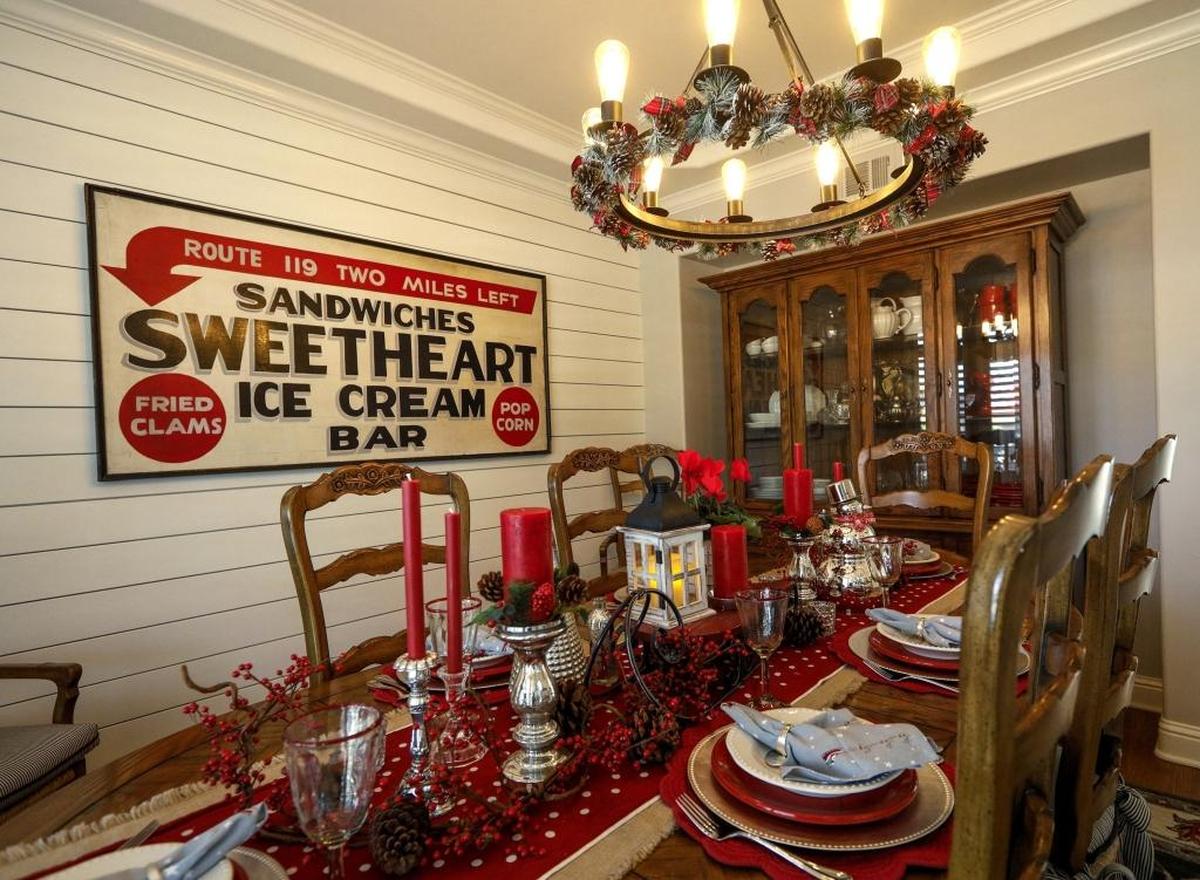 A large 1940s metal restaurant sign lends industrial edge to the traditional-style dining room of the Palmer home in San Luis Obispo.
