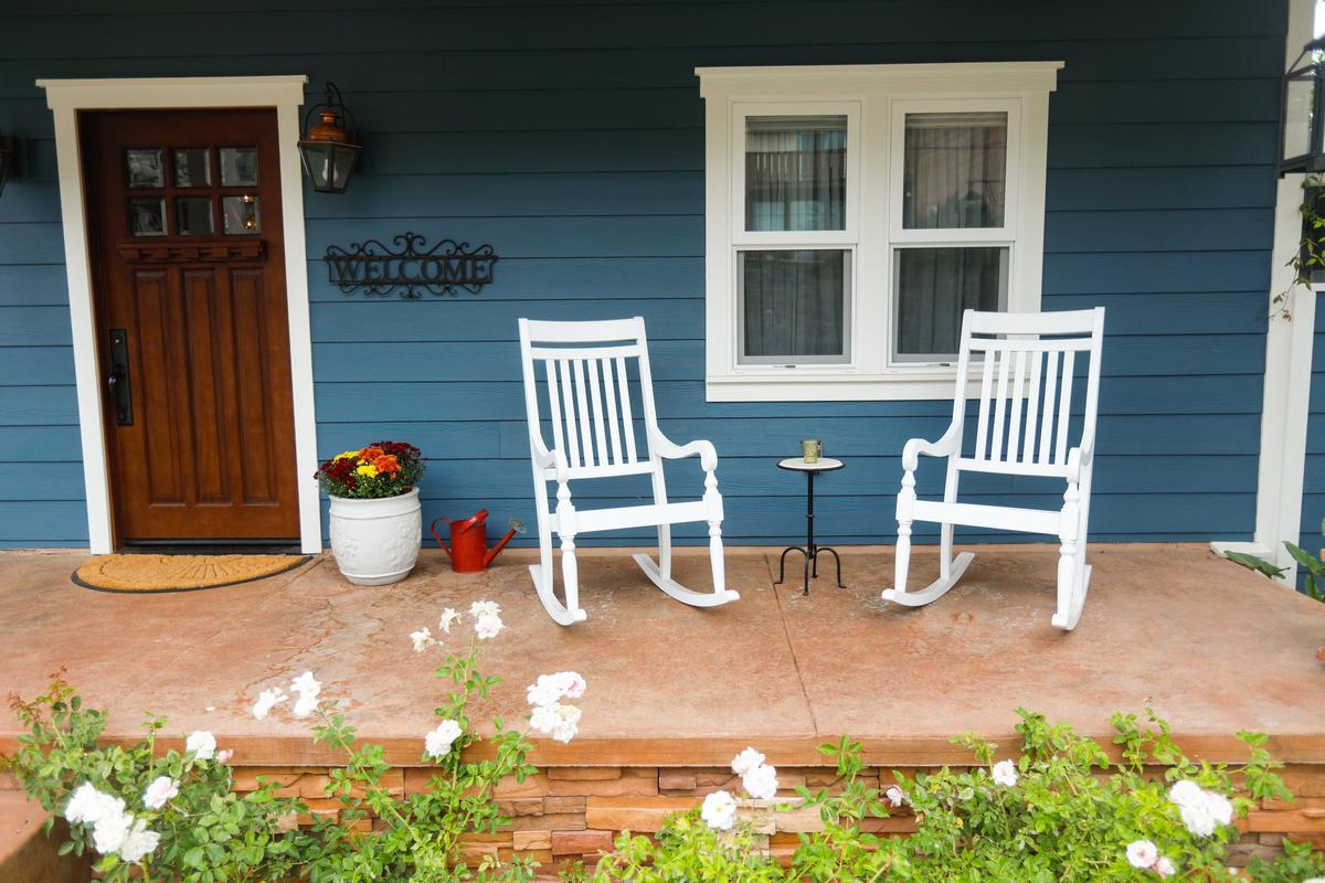 White rocking chairs sit on the front porch of Marilyn Hotz’s home.
