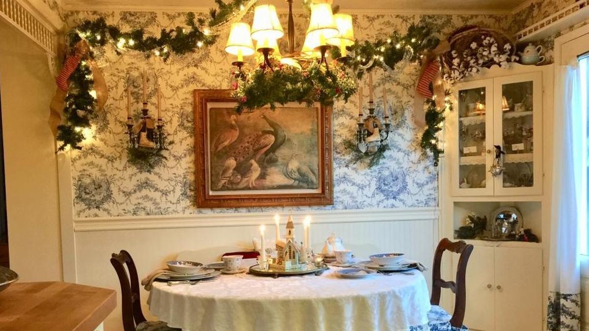 Traditional holiday decorations complement the antiques in Travis and Steve Srott’s English-style cottage in Cambria.