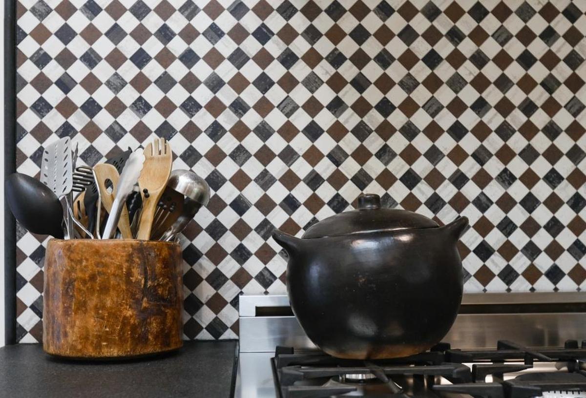The home’s vintage details include a checkerboard porcelain tile for the backsplash in the kitchen.
