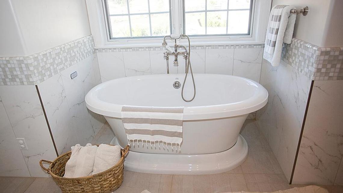 A palette of tonal whites — colors like cream, taupe, beige or gray — can be restful in a master bath.