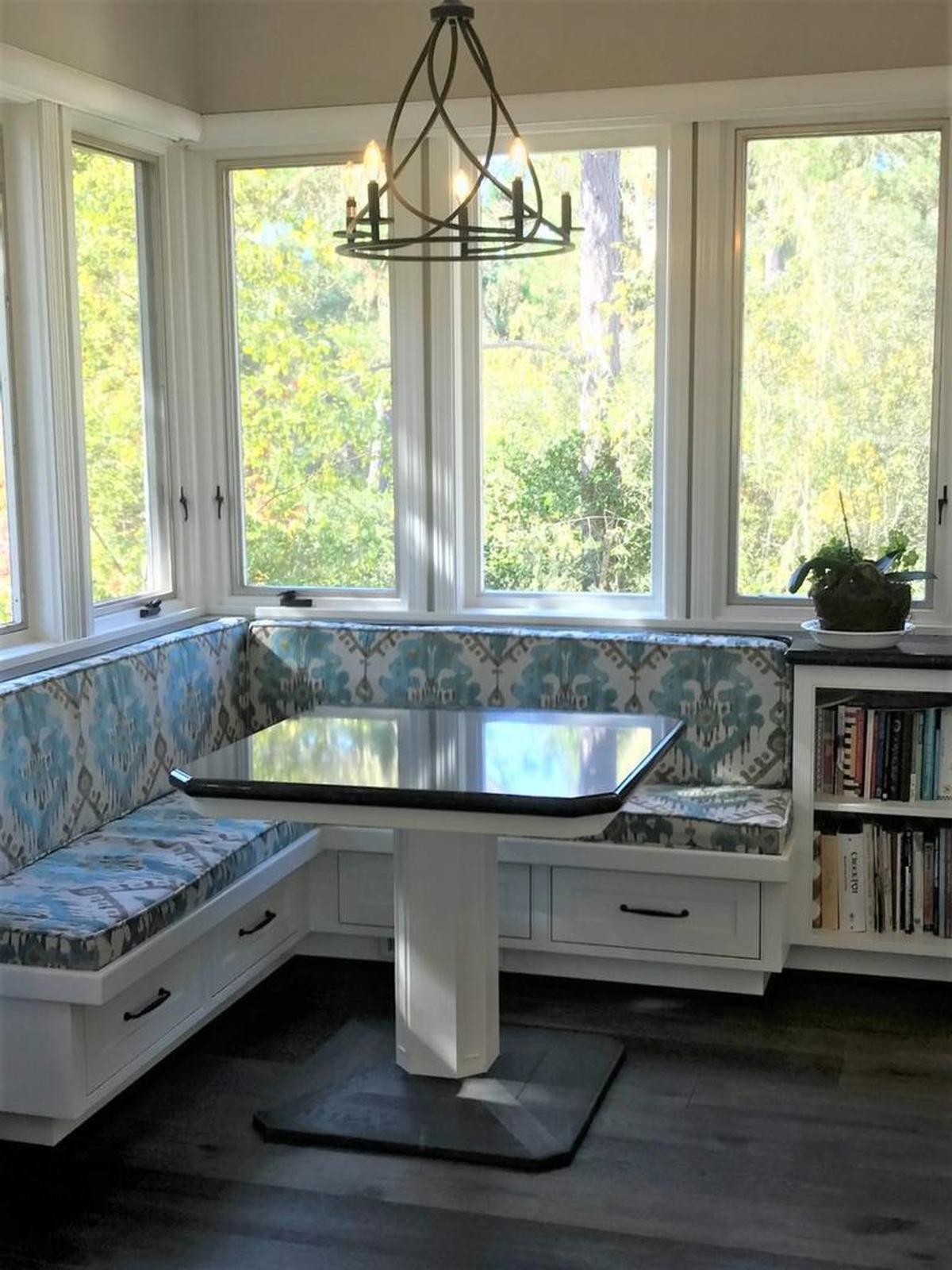A new banquette provides a space for casual dining with a view of the wooded hillside at the Clark home in Cambria.