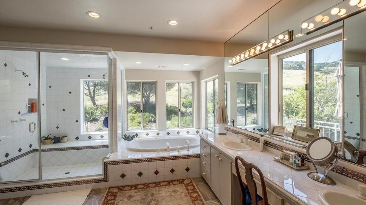 The master bathroom of this San Luis Obispo home features one-way glass windows so that owners Bill and Sandee Beckers can enjoy the vista even while taking a soak or shower.