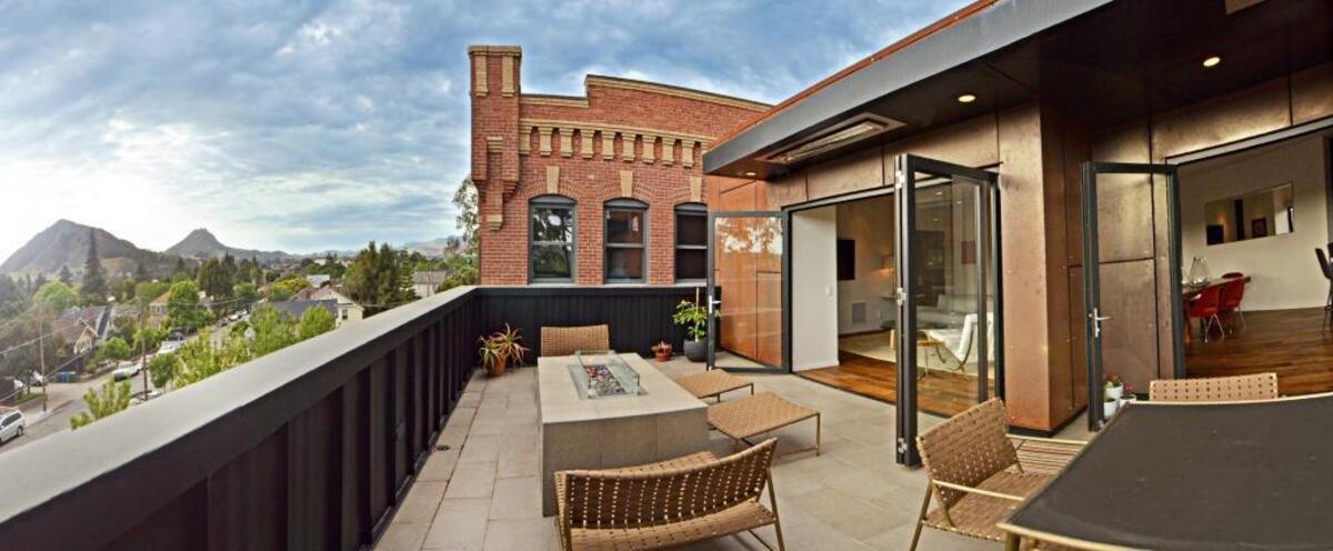 Folding glass doors at Michelle Borrero’s San Luis Obispo loft open to a patio that offers sweeping views of the mountains and the city.