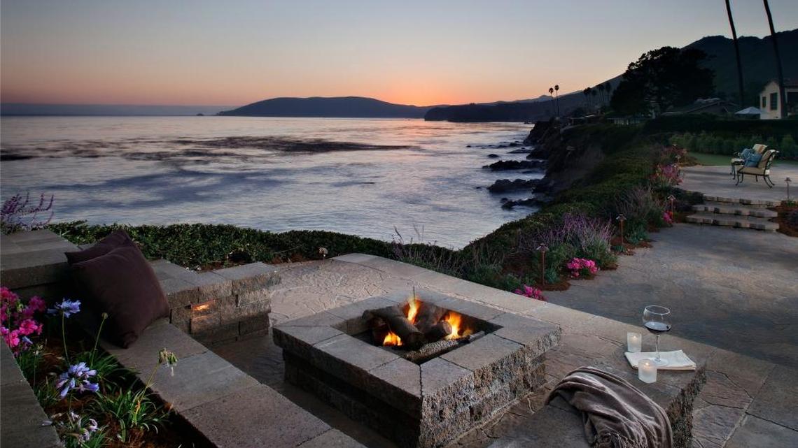 A fire pit with seating and an ocean view makes for an attractive gathering spot.