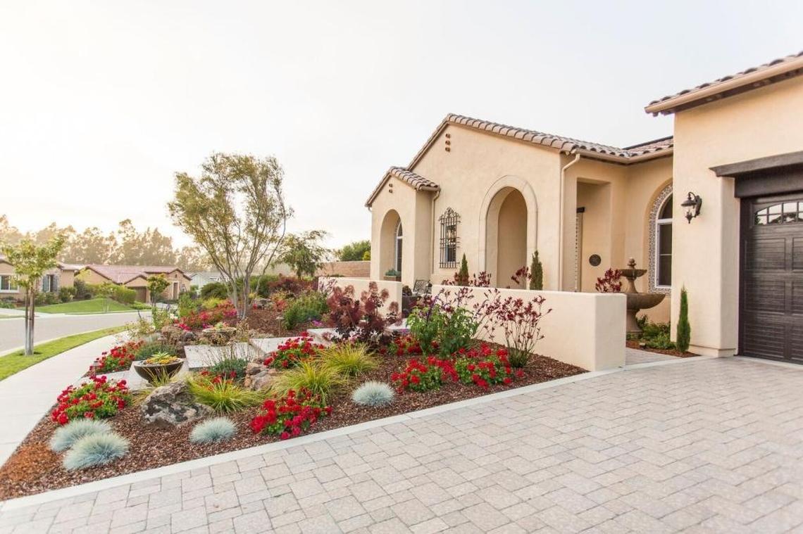 The couple was so pleased with their backyard that they asked Addison Landscape to redesign their front yard as well. New elements include dry-stack retaining walls and Mediterranean-inspired plants.