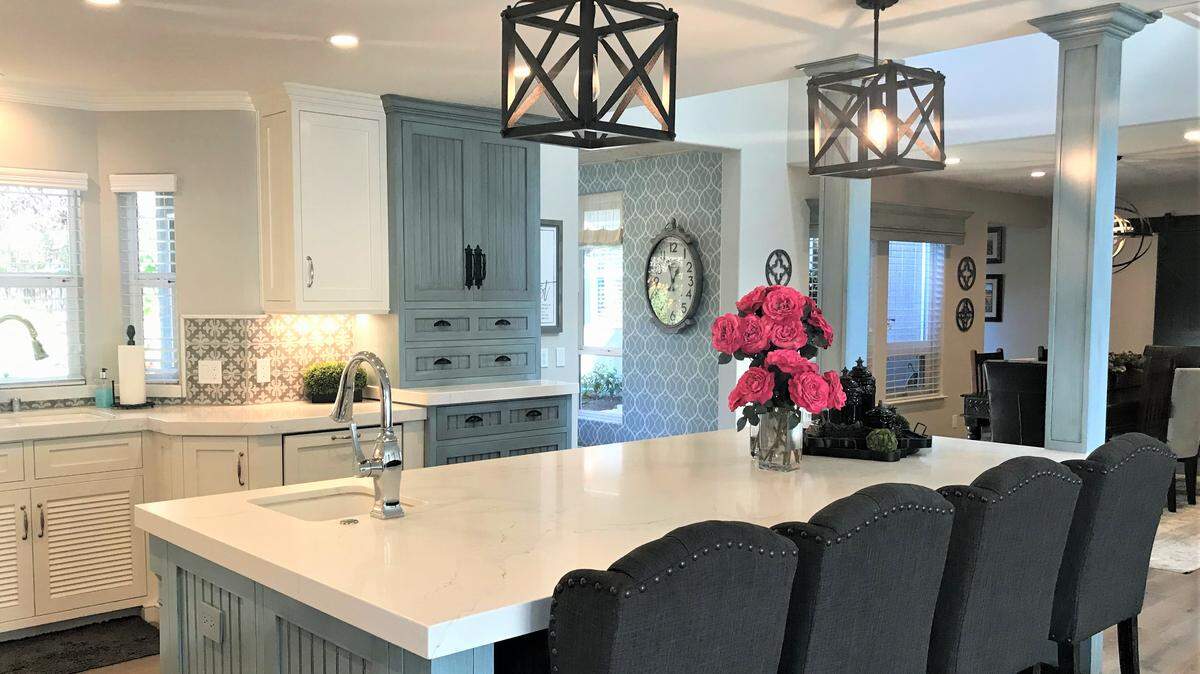 The kitchen of Jeff and Melinda Baker’s Cambria home features Shaker-style cabinets and a 10-foot-long island with a sink.
