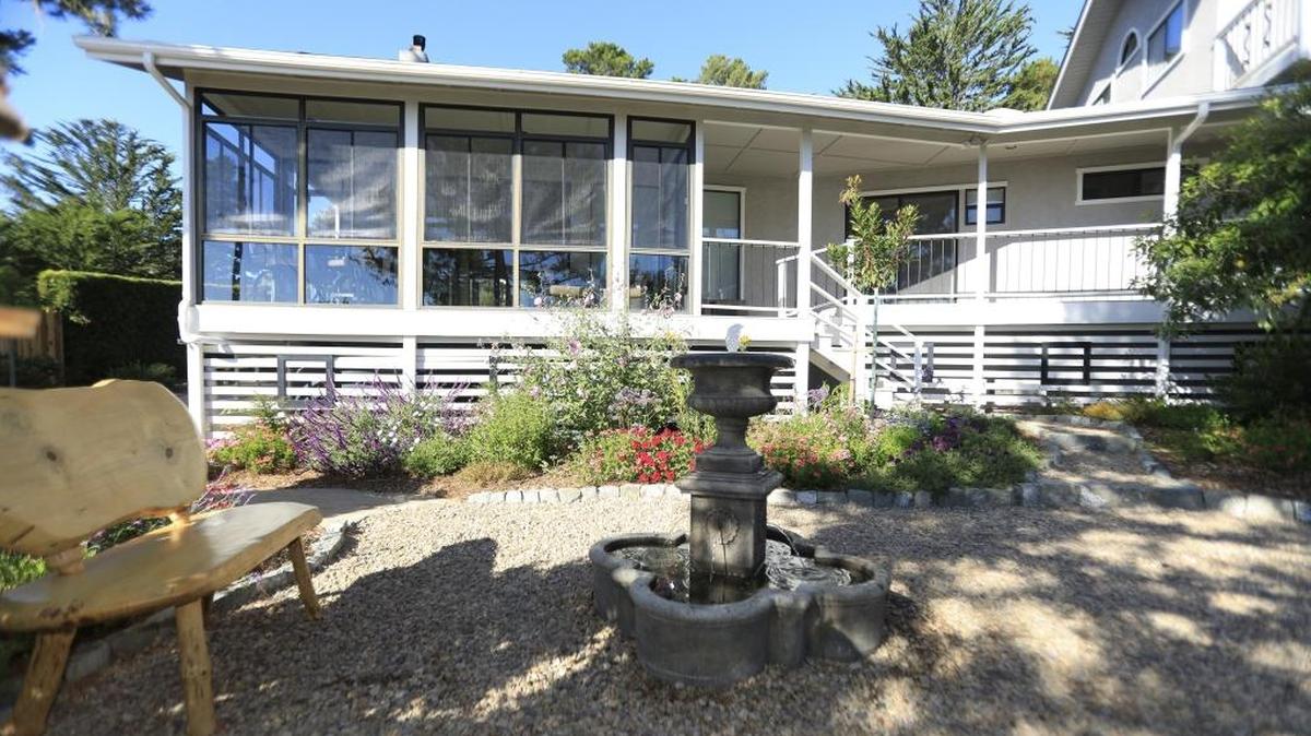 An outdoor seating area behind Doug and Shelly Schultz’s Cambria home offers tranquil views.