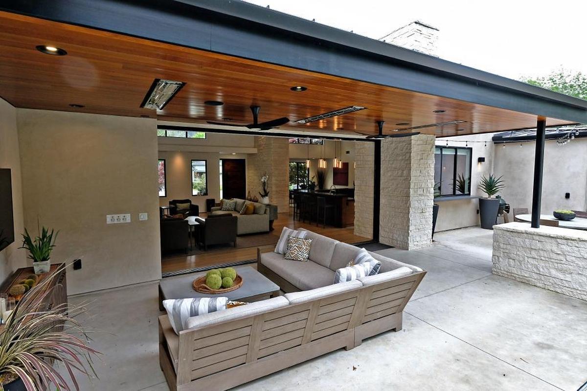 The Okimotos’ rear balcony has comfortable seating and a flat-screen television.