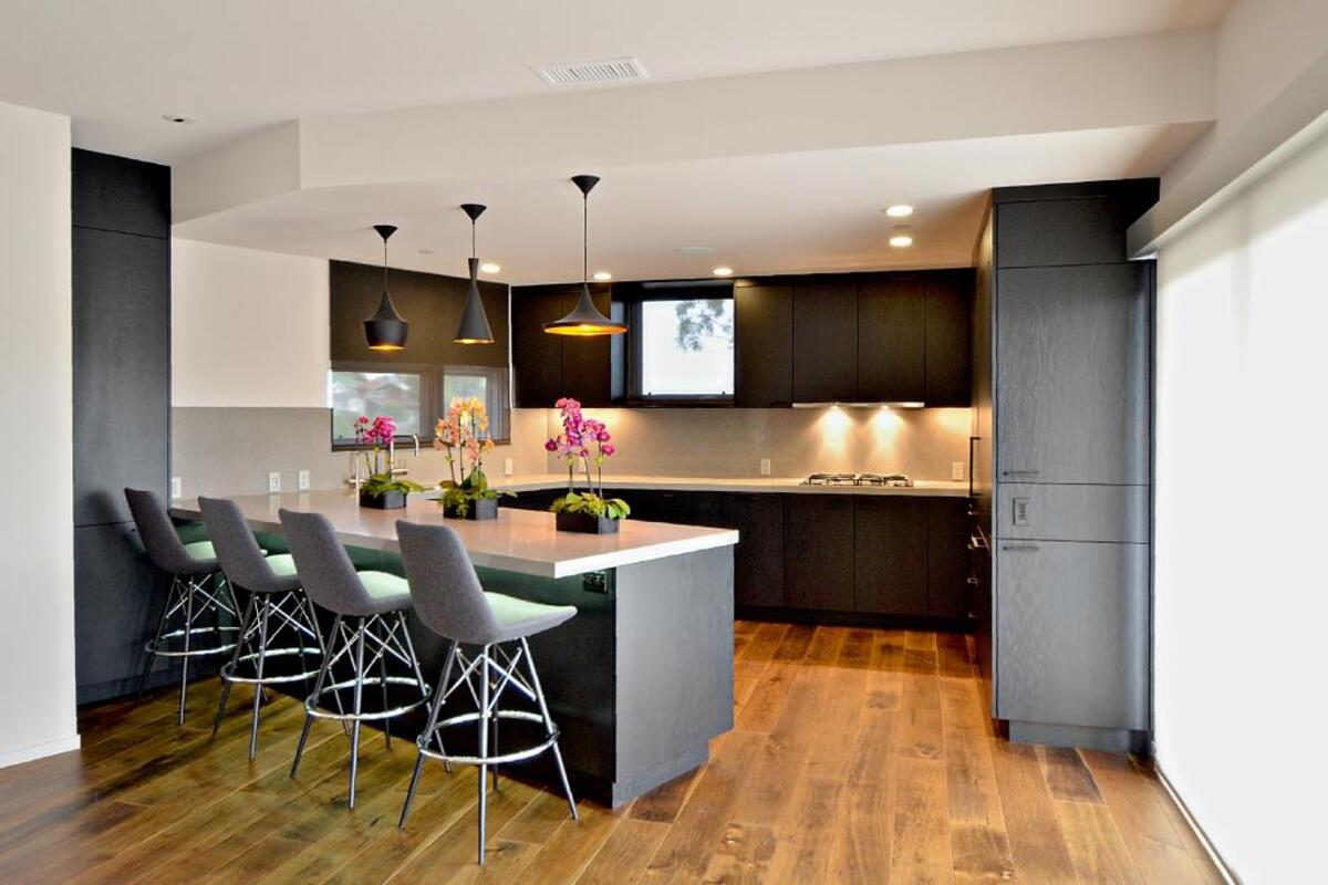 Rustic oak floors warm up the hard lines and cool tones of the Borreros' kitchen.