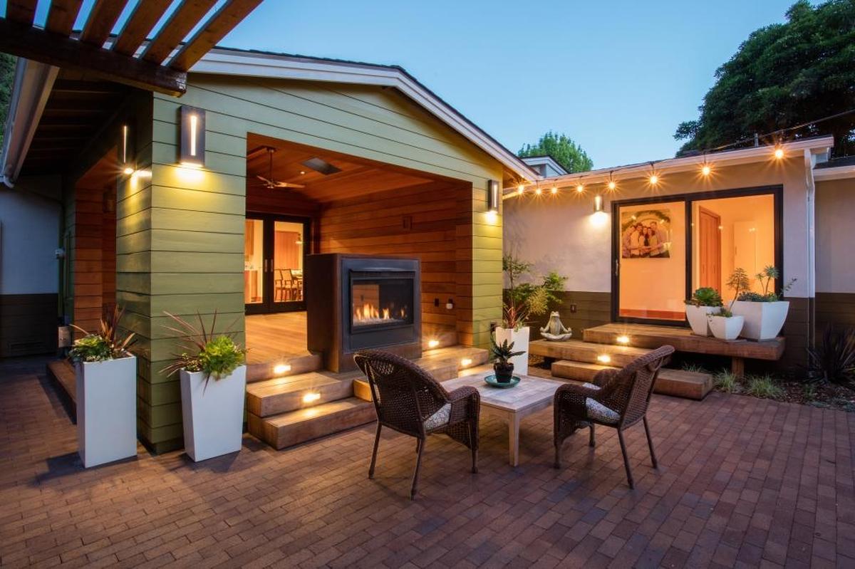 A covered patio in the backyard looks as if it was carved from a solid block of wood.