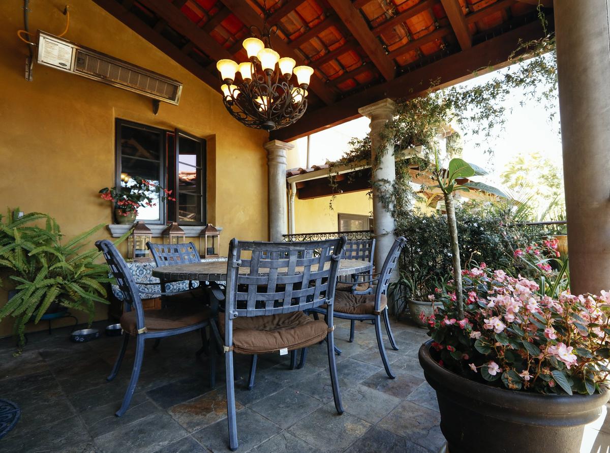 Flowering vines wreathe a patio at Rushdi and Nisha Abdul Cader's San Luis Obispo home.