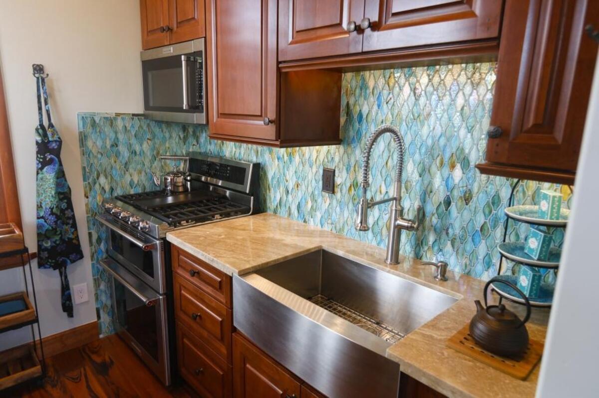 Peacock-colored glass tiles add an element of luxury to the kitchen of the Peacock Suite, the Abdul Cader family’s San Luis Obispo guest suite.