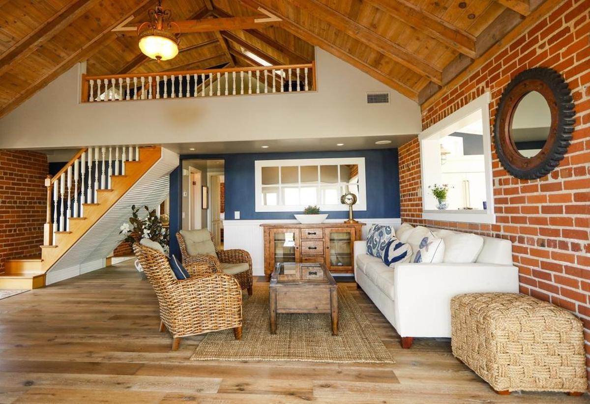 The living room has a staircase leading to a loft bedroom.