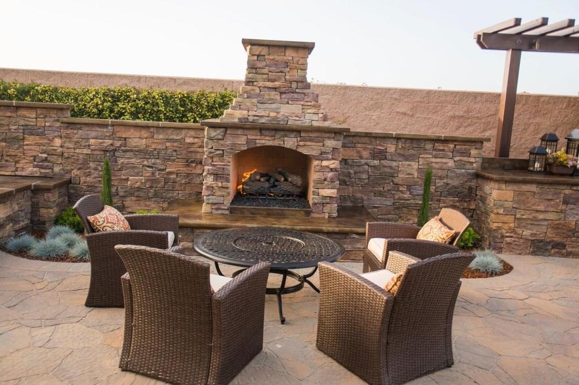 The outdoor fireplace area offers plenty of comfortable seating.