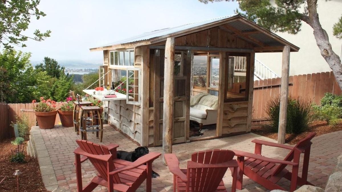 Vanessa Henson’s she-shed in Los Osos has a large window built from a salvaged door that sits sideways and opens to create an outdoor bar, with views of Morro Rock.