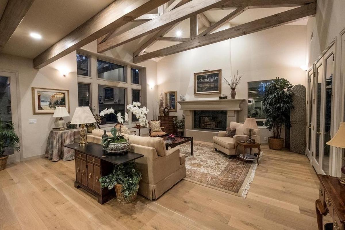 Bill and Sandee Beckers chose a new, nature-inspired color palette when remodeling their San Luis Obispo home. The living room features beige walls, taupe ceiling beams and wide-plank wood flooring in a natural finish.